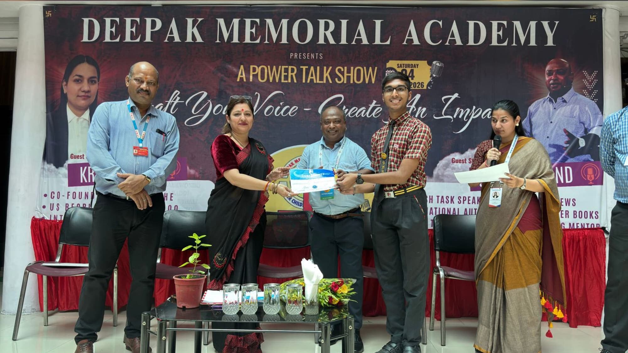 A student receiving a certificate at the Aao Seekhe power talk show hosted at Deepak Memorial Academy